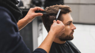 Image of man preening hair for story on men's grooming