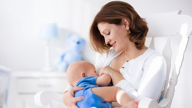 Mum and baby breast-feeding