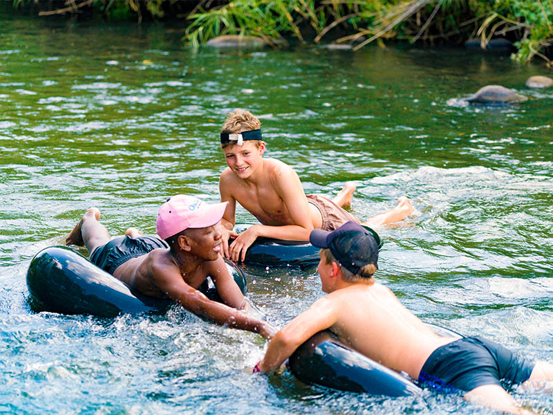 Boys swimming in the river for article on Hilton College boarding school for boys in South Africa