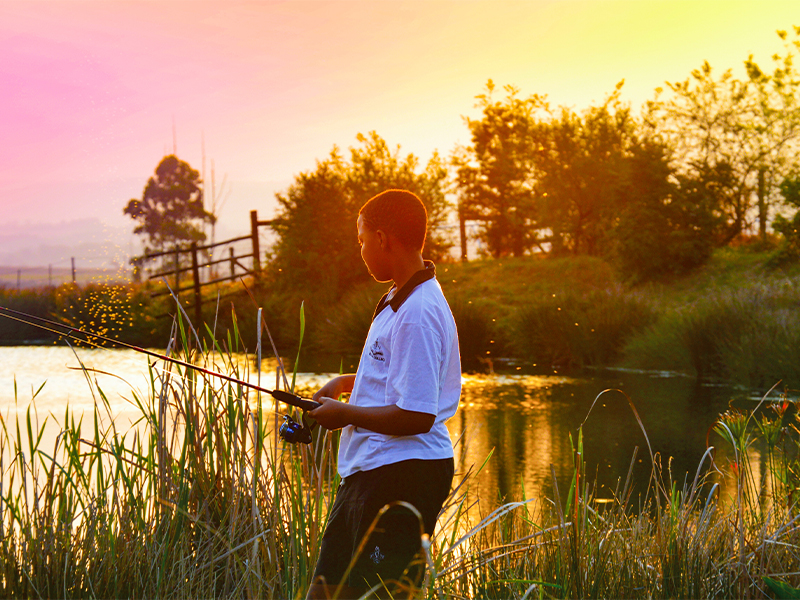 boy fishing for article on Hilton College, on of the best boarding schools in South Africa